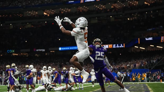 Texas Longhorns wide receiver Adonai Mitchell (5) makes a touchdown catch over Washington cornerback Elijah Jackson during the Sugar Bowl College Football Playoff semifinals game at the Caesars Superdome on Monday, Jan. 1, 2024 in New Orleans, Louisiana. The catch would be the last touchdown for the Longhorns in the 31-37 loss to Washington.  © Aaron E. Martinez/American-Statesman / USA TODAY NETWORK  